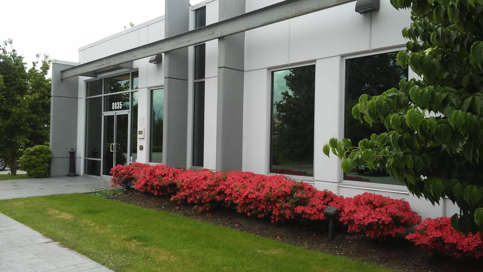 Front entrance to the Vancouver based Tippet Richardson building with red flowers